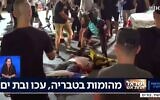 A man beats a man lying prone on the ground in Bat Yam, amid interethnic violence across Israel, May 12, 2021. (Kan TV Screenshot)