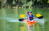Illustrative: Two boys kayaking down a river at summer camp (Yobro10; iStock by Getty Images)
