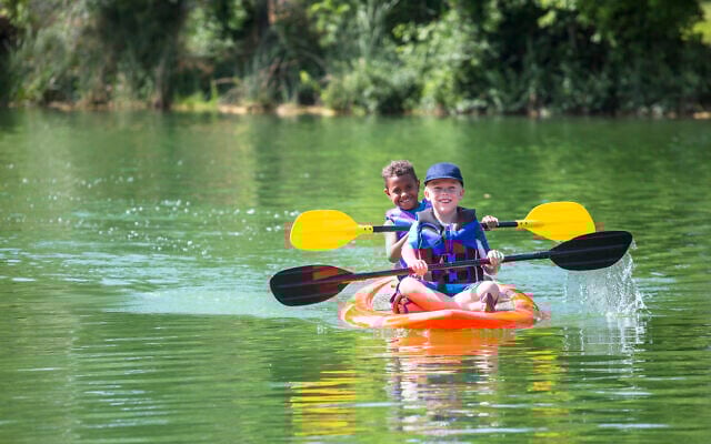 Illustrative: Two boys kayaking down a river at summer camp (Yobro10; iStock by Getty Images)