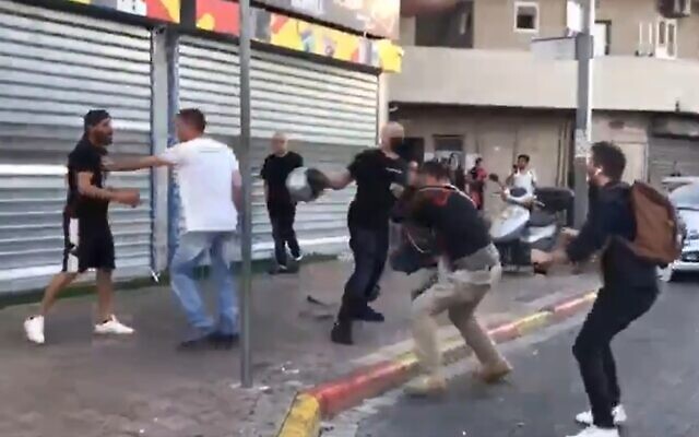 Reporters for the Kan public broadcaster are beaten in the Tikva neighborhood of Tel Aviv, May 13 , 2021 (Screen grab/Twitter) Reporters for the Kan public broadcaster are beaten in the Tikva neighborhood of Tel Aviv, May 13 , 2021 (Screen grab/Twitter)