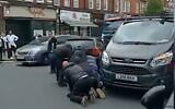 People restrain a man accused of attacking an ultra-Orthodox Jew in London on May 21, 2021 (Screencapture/YouTube)