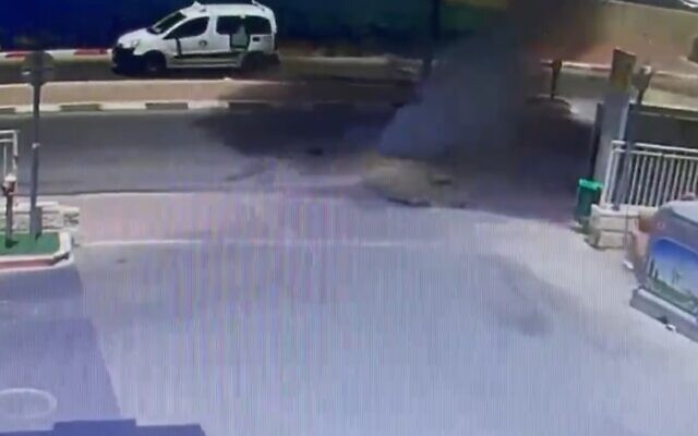 The moment a rocket slammed into the road outside a gas station in Netivot, May 16, 2021 (Screen grab/Kann) The moment a rocket slammed into the road outside a gas station in Netivot, May 16, 2021 (Screen grab/Kann)