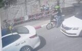 In this image from video released by Israel's Police, a man can be seen on an electric bike carrying his newborn child in a basket, in Tel Aviv, on May 5, 2021. (Israel Police)