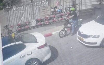 In this image from video released by Israel's Police, a man can be seen on an electric bike carrying his newborn child in a basket, in Tel Aviv, on May 5, 2021. (Israel Police)