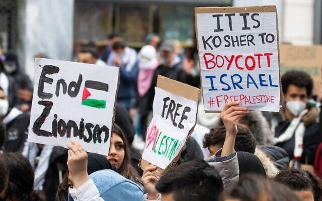 Demonstrators against Israel hold signs at a rally in Vienna, Austria, where protesters chanted in Arabic about a massacre of Jews, May 13, 2021. (Courtesy of Austrian Union of Jewish Students via JTA) Demonstrators against Israel hold signs at a rally in Vienna, Austria, where protesters chanted in Arabic about a massacre of Jews, May 13, 2021. (Courtesy of Austrian Union of Jewish Students via JTA)