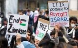 Illustrative: Demonstrators against Israel hold signs at a rally in Vienna, Austria, where protesters chanted in Arabic about a massacre of Jews, May 13, 2021. (Courtesy of Austrian Union of Jewish Students via JTA)