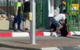People attempt to subdue an assailant with a knife outside the Soroka Medical Center in Beersheba on May 11, 2021. (Screenshot)