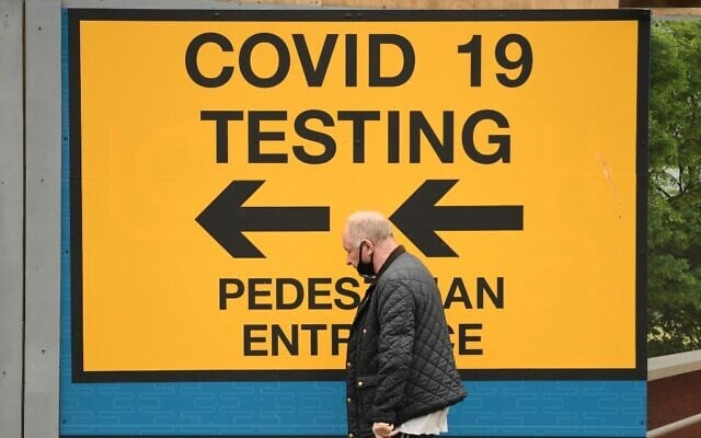 A person walks past a sign directing members of the public to a COVID-19 testing centre in Bolton, northwest England, on May 28, 2021. (Oli SCARFF / AFP) A person walks past a sign directing members of the public to a COVID-19 testing centre in Bolton, northwest England, on May 28, 2021. (Oli SCARFF / AFP)