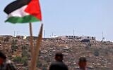 Palestinian protesters attend a demonstration against the Evyatar settlement outpost, south of Nablus, on June 4, 2021, in the West Bank. (JAAFAR ASHTIYEH / AFP)