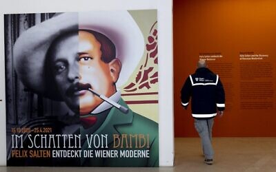 A man passes by a poster of Felix Salten (L) as he enters the exhibition 'Beyond Bambi - Felix Salten and the Discovery of Viennese Modernism,' at the Wien Museum in Vienna, Austria, on March 23, 2021. (Joe Klamar/AFP)