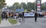 People march past the Cherryhill Village Mall parking lot where Nathaniel Veltman was arrested during the multi-faith march to end hatred, in London, Ontario, Canada, on June 11, 2021. (Nicole OSBORNE / AFP)