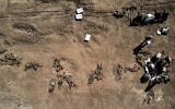 This aerial view taken on June 13, 2021, shows human remains, reportedly of victims of the 2014 Badush prison massacre committed by the Islamic State (IS) group, after being unearthed from a mass grave in the northern Iraqi village of Badush, northwest of the city of Mosul. (Zaid AL-OBEIDI/AFP)