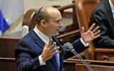 Prime Minister-designate Naftali Bennett addresses the Knesset, June 13, 2021. (EMMANUEL DUNAND / AFP)