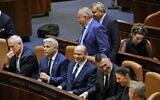 Sitting from left to right: Defense Minister Benny Gantz, Foreign Minister Yair Lapid, Prime Minister Naftali Bennett, Justice Minister Gideon Sa'ar, Transportation Minister Merav Michaeli and Health Minister Nitzan Horowitz, as Finance Minister Avigdor Lieberman and Housing Minister Ze'ev Elkin walk past after a special Knesset plenum session to approve the new government, June 13, 2021. (Emmanuel Dunand/AFP)