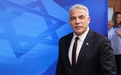 Foreign Minister Yair Lapid arrives for the weekly cabinet meeting at the Prime Minister's Office in Jerusalem, on June 20, 2021. (Emmanuel Dunand/Pool/AFP)