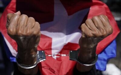 Cuban anti-government protesters demonstrate outside the UN on June 23, 2021 as the UN holds a session on  the necessity of ending the economic, commercial and financial embargo imposed by the US against Cuba (Photo by TIMOTHY A. CLARY / AFP)