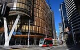 A tram commutes on a street in Sydney on June 26, 2021, after authorities locked down several central areas of Australia's largest city to contain an outbreak of the highly contagious Delta variant. (SAEED KHAN / AFP)