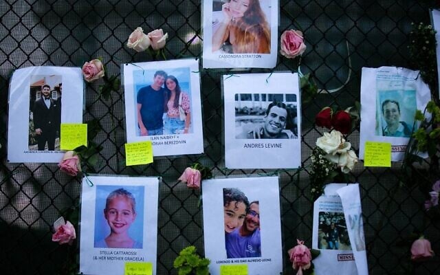 Photos of missing residents are posted at a makeshift memorial at the site of a collapsed building in Surfside, Florida, north of Miami Beach,on June 26, 2021 (Photo by Andrea SARCOS / AFP) Photos of missing residents are posted at a makeshift memorial at the site of a collapsed building in Surfside, Florida, north of Miami Beach,on June 26, 2021 (Photo by Andrea SARCOS / AFP)