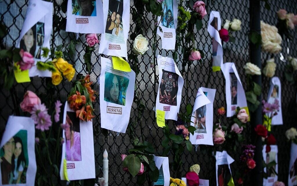 Photos of missing residents are posted at a makeshift memorial at the site of a collapsed building in Surfside, Florida, north of Miami Beach, on June 26, 2021 (Andrea SARCOS / AFP)