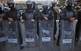 Palestinian security forces block a road during a demonstration in the city of Ramallah in the West Bank, on June 26, 2021, protesting the death of human rights activist Nizar Banat while in the custody of Palestinian Authority (PA) security forces. (Ahmad Gharabli/AFP)