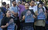 Palestinians hold posters depicting human rights activist Nizar Banat during a protest triggered by the violent arrest and death in custody of Banat, in his hometown of Hebron in the West Bank, on June 27, 2021. (MOSAB SHAWER / AFP)