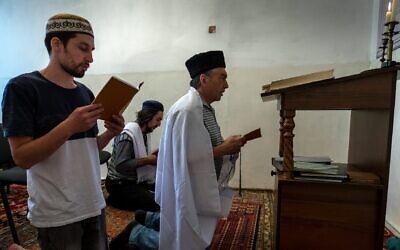Crimean Karaites attend a religious service in a room outside their house of worship in Simferopol, Crimea, June 9, 2018. (Sergei Malgavko/TASS via Getty Images via JTA)