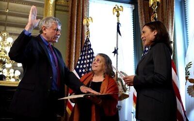 Eric Lander, the incoming director of the White House Office of Science and Technology Policy, participates in a swearing-in ceremony with US Vice President Kamala Harris in her ceremonial office, as his wife Lori Lander holds a 13-page fragment of a Pirkei Avot text from 1492 in the Eisenhower Executive Office Building on June 2, 2021 in Washington, DC. (Anna Moneymaker/Getty Images/AFP)