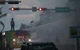 Miami-Dade Fire Rescue personnel spray water on a fire in the partially collapsed 12-story Champlain Towers South condo building as search and rescue operations continue on June 25, 2021 in Surfside, Florida. (Joe Raedle/Getty Images/AFP)
