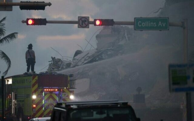 Miami-Dade Fire Rescue personnel spray water on a fire in the partially collapsed 12-story Champlain Towers South condo building as search and rescue operations continue on June 25, 2021 in Surfside, Florida. (Joe Raedle/Getty Images/AFP) Miami-Dade Fire Rescue personnel spray water on a fire in the partially collapsed 12-story Champlain Towers South condo building as search and rescue operations continue on June 25, 2021 in Surfside, Florida. (Joe Raedle/Getty Images/AFP)