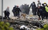 Members of the South Florida Urban Search and Rescue team look for possible survivors in the partially collapsed 12-story Champlain Towers South condo building on June 25, 2021 in Surfside, Florida (JOE RAEDLE / GETTY IMAGES NORTH AMERICA / Getty Images via AFP)