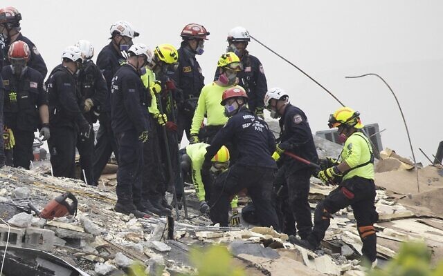 Members of the South Florida Urban Search and Rescue team look for possible survivors in the partially collapsed 12-story Champlain Towers South condo building, on June 25, 2021, in Surfside, Florida (Joe Raedle / Getty Images North America / Getty Images via AFP) Members of the South Florida Urban Search and Rescue team look for possible survivors in the partially collapsed 12-story Champlain Towers South condo building, on June 25, 2021, in Surfside, Florida (Joe Raedle / Getty Images North America / Getty Images via AFP)
