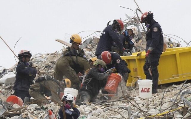 Search and Rescue teams look for possible survivors and to recover remains in the partially collapsed 12-story Champlain Towers South condo building on June 29, 2021 in Surfside, Florida. (Joe Raedle/Getty Images/AFP) Search and Rescue teams look for possible survivors and to recover remains in the partially collapsed 12-story Champlain Towers South condo building on June 29, 2021 in Surfside, Florida. (Joe Raedle/Getty Images/AFP)