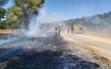 Fire and rescue services put out a fire allegedly sparked in the Western Negev by arson balloons launched by Gaza terrorists, June 16, 2021. (Itzik Lugasi/KKL-JNF)