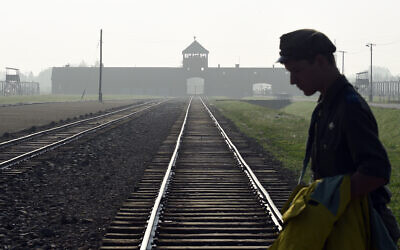 A man crosses the rails at the former Nazi German death camp of Birkenau in Oswiecim, Poland, July 29, 2016. (AP/Alik Keplicz)