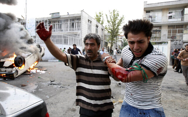 Illustrative -- In this June 15, 2009 file photo, a protester allegedly injured by gunfire from a pro-government militia is helped by another protester near a rally supporting leading opposition presidential candidate Mir Hossein Mousavi in Tehran, Iran (AP photo/Vahid Salemi, File) Illustrative -- In this June 15, 2009 file photo, a protester allegedly injured by gunfire from a pro-government militia is helped by another protester near a rally supporting leading opposition presidential candidate Mir Hossein Mousavi in Tehran, Iran (AP photo/Vahid Salemi, File)