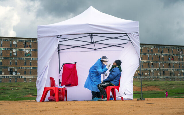 In this Wednesday, April 29, 2020 file photo, a resident from the Alexandra township gets tested for the new coronavirus, in Johannesburg, South Africa. (AP Photo/Jerome Delay, File) In this Wednesday, April 29, 2020 file photo, a resident from the Alexandra township gets tested for the new coronavirus, in Johannesburg, South Africa. (AP Photo/Jerome Delay, File)