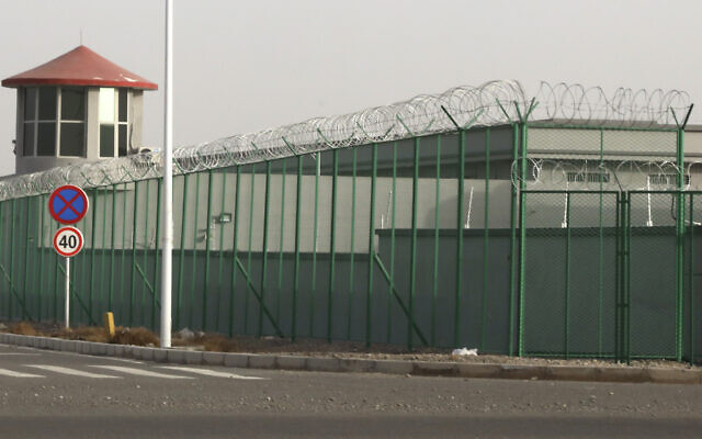 A guard tower and barbed wire fence surround a detention facility in the Kunshan Industrial Park in Artux in western China's Xinjiang region. December 3, 2018. (AP Photo/Ng Han Guan, File) A guard tower and barbed wire fence surround a detention facility in the Kunshan Industrial Park in Artux in western China's Xinjiang region. December 3, 2018. (AP Photo/Ng Han Guan, File)