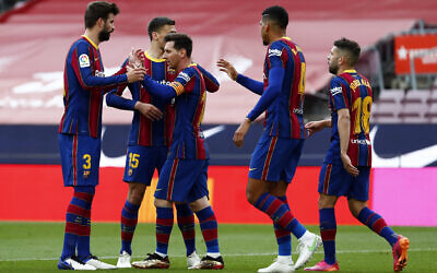 Barcelona's Lionel Messi celebrates with team mates scoring the opening goal during the Spanish La Liga soccer match between FC Barcelona and Celta at the Camp Nou stadium in Barcelona, Spain, May 16, 2021. (AP/Joan Monfort)