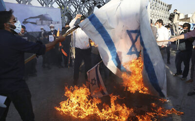 Demonstrators burn representations of the Israeli flag during pro-Palestinian demonstrations in Tehran, Iran, May 19, 2021. (Vahid Salemi/AP/File)