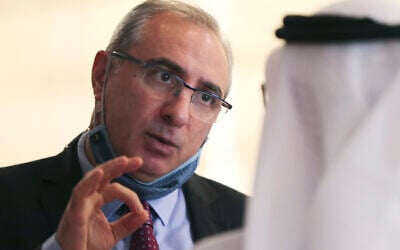 Israel's then-ambassador to the UAE, Eitan Na'eh, left, talks with an Emirati official during the Global Investment Forum in Dubai, United Arab Emirates on June 2, 2021. (AP/Kamran Jebreili)