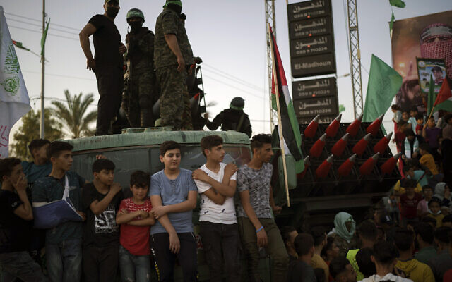 Palestinians gather as Hamas members parade at a rally just over a week after a ceasefire was reached in an 11-day war between the terror group and Israel, May 30, 2021, in Beit Lahia, northern Gaza Strip. (AP Photo/Felipe Dana) Palestinians gather as Hamas members parade at a rally just over a week after a ceasefire was reached in an 11-day war between the terror group and Israel, May 30, 2021, in Beit Lahia, northern Gaza Strip. (AP Photo/Felipe Dana)