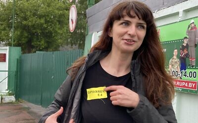 In this Wednesday, May 19, 2021 file photo, Belarusian journalist Katsiaryna Barysevich, who was sentenced to six months over her investigation into a protester's death, shows her yellow prison's label to colleagues upon her release from the prison in Komarovka, Belarus (AP Photo)