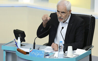 In this photo made available by the government-affiliated Young Journalists Club, presidential candidate Mohsen Mehralizadeh speaks in a televised debate in a state-run television studio, in Tehran, Iran, on Saturday, June 5, 2021. Elections are scheduled for June 18. (Morteza Fakhri Nezhad/YJC via AP)