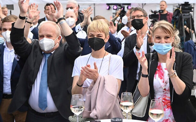 Supporters of Merkel's Christian Democratic Union party, CDU, react after the first exit poll for the Saxony-Anhalt state elections announced in Magdeburg, Germany, June 6, 2021. (Bernd Von Jutrczenka/ dpa via AP)