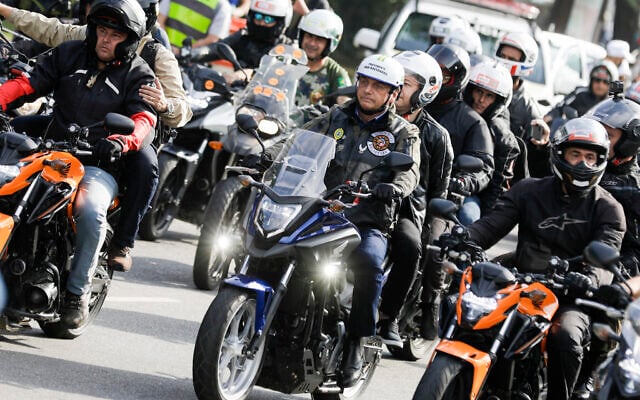 Brazil's President Jair Bolsonaro, center, takes part in a caravan of motorcycle enthusiasts who gathered in a show of support for Bolsonaro, in Sao Paulo, Brazil, June 12, 2021. (AP Photo/Marcelo Chello) Brazil's President Jair Bolsonaro, center, takes part in a caravan of motorcycle enthusiasts who gathered in a show of support for Bolsonaro, in Sao Paulo, Brazil, June 12, 2021. (AP Photo/Marcelo Chello)
