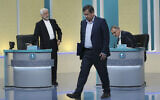 In this picture made available by Young Journalists Club, YJC, presidential candidates for June 18, elections Saeed Jalili, left, Abdolnasser Hemmati, center, and Alireza Zakani, conclude a part of the final debate of the candidates at a state-run TV studio in Tehran, Iran, Saturday, June 12, 2021. (Morteza Fakhri Nezhad/ Young Journalists Club, YJC via AP)