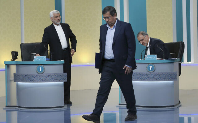 In this picture made available by Young Journalists Club, YJC, presidential candidates for June 18, elections Saeed Jalili, left, Abdolnasser Hemmati, center, and Alireza Zakani, conclude a part of the final debate of the candidates at a state-run TV studio in Tehran, Iran, Saturday, June 12, 2021. (Morteza Fakhri Nezhad/ Young Journalists Club, YJC via AP) In this picture made available by Young Journalists Club, YJC, presidential candidates for June 18, elections Saeed Jalili, left, Abdolnasser Hemmati, center, and Alireza Zakani, conclude a part of the final debate of the candidates at a state-run TV studio in Tehran, Iran, Saturday, June 12, 2021. (Morteza Fakhri Nezhad/ Young Journalists Club, YJC via AP)