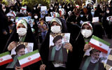 Supporters of presidential candidate Ebrahim Raisi hold signs during a rally in Tehran, Iran, June 16, 2021. (AP Photo/Ebrahim Noroozi)