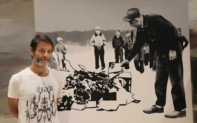 Polish artist Wilhelm Sasnal poses in front of one of his art works on display in a new exhibition at the POLIN Museum of the History of Polish Jews, in Warsaw, Poland, on June 15, 2021. (Czarek Sokolowski/AP)