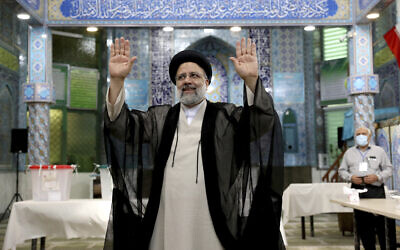 Ebrahim Raisi, who went on to win Iran's presidential election, waves after casting his vote at a polling station in Tehran, Iran, on June 18, 2021. (Ebrahim Noroozi/AP)